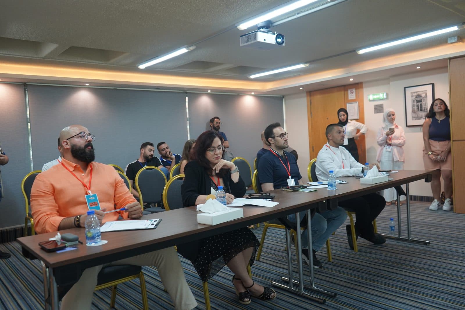 Experts seated at long tables during a product assessment session at the Gourmet Market