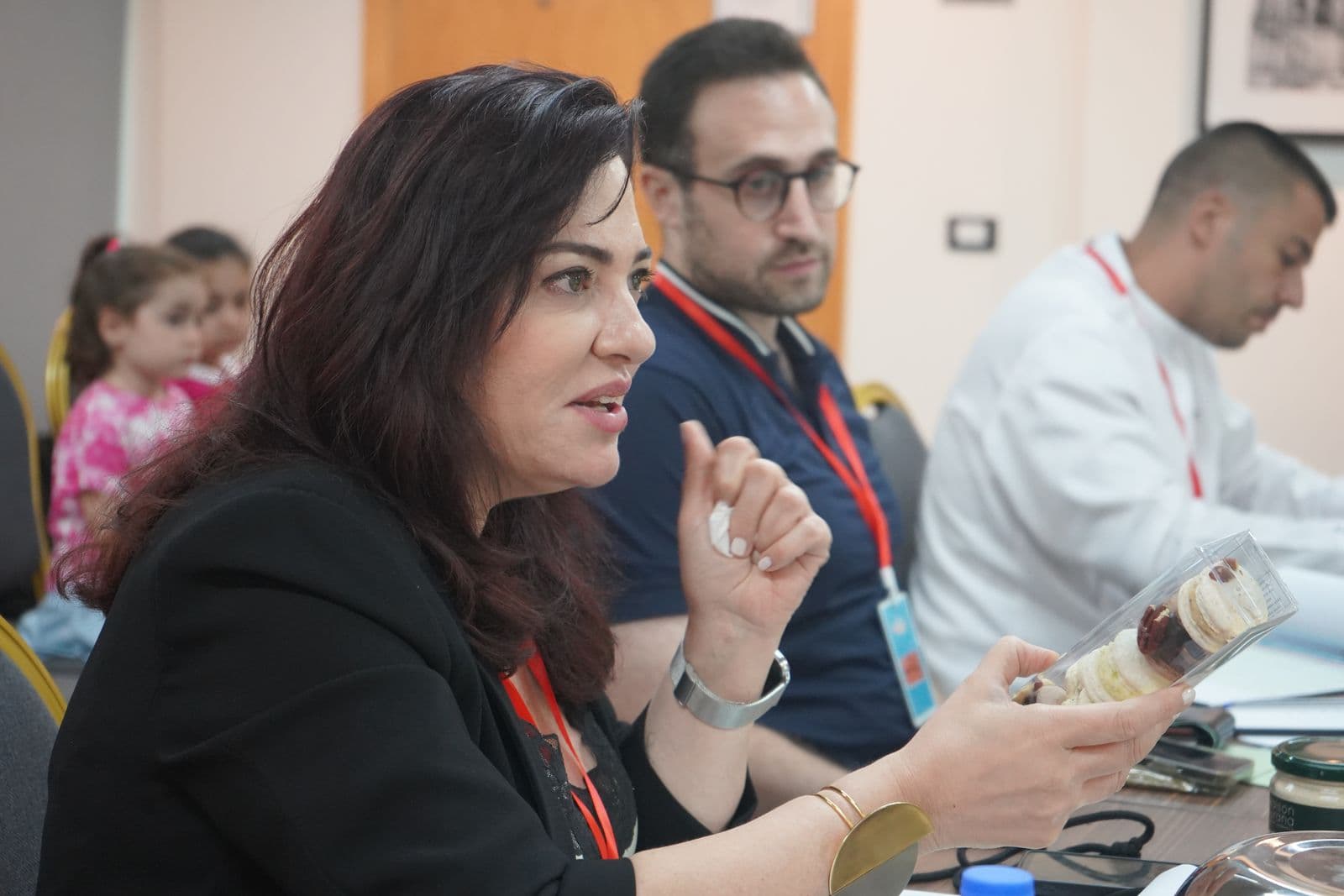 A panel tastes and evaluates food products at a table during the Gourmet Market