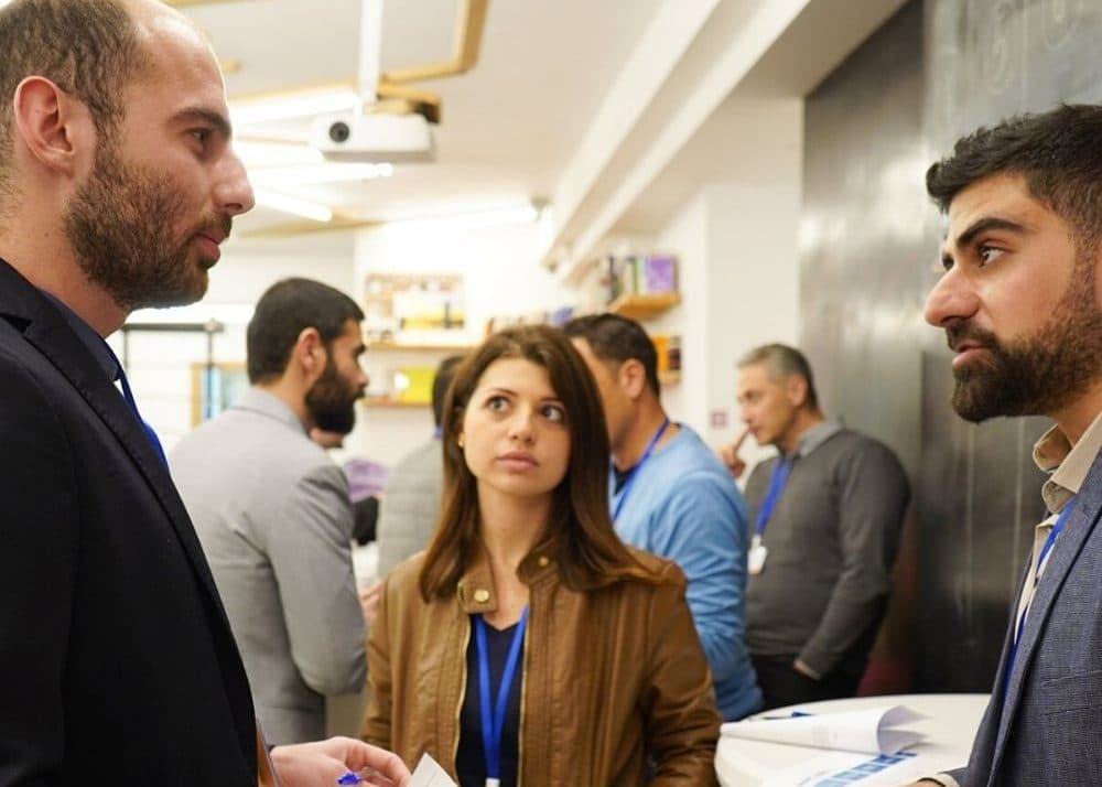 Business owners talk in a small group during a networking break