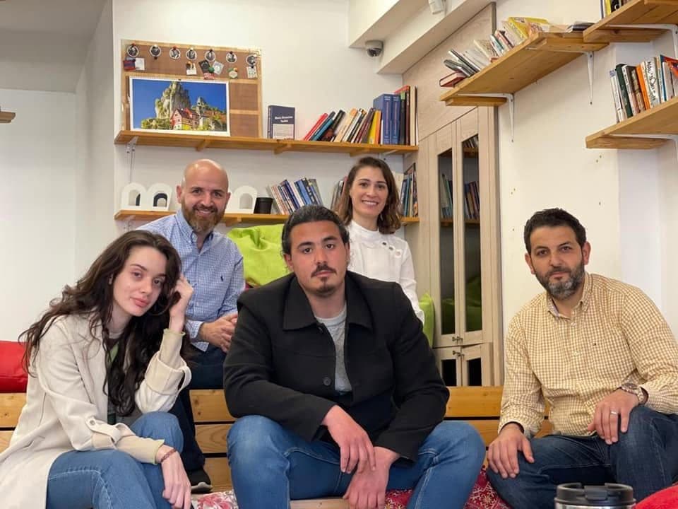 Business owners and coaches pose together in a coworking space